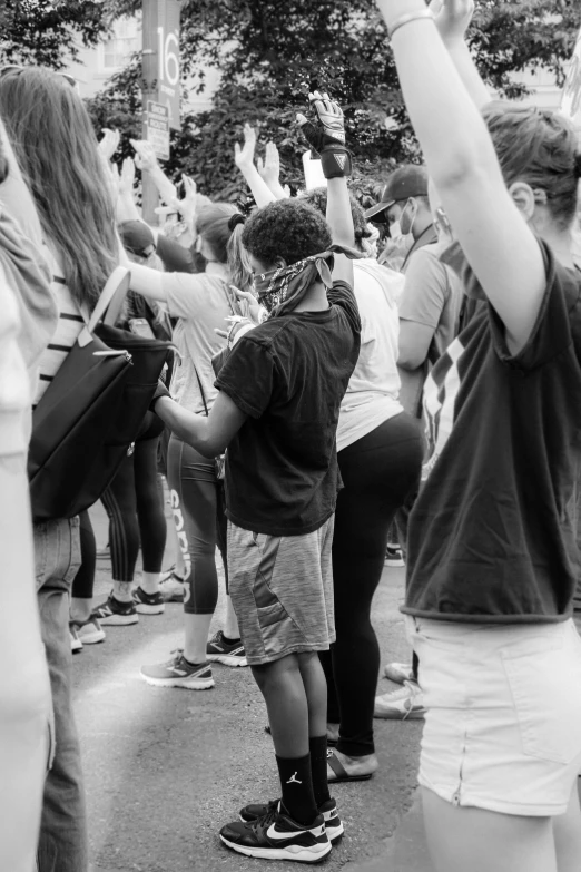 a crowd of people dancing on a sidewalk