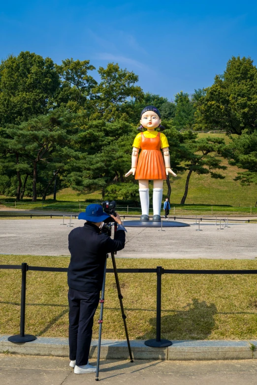 someone taking pictures of a large statue