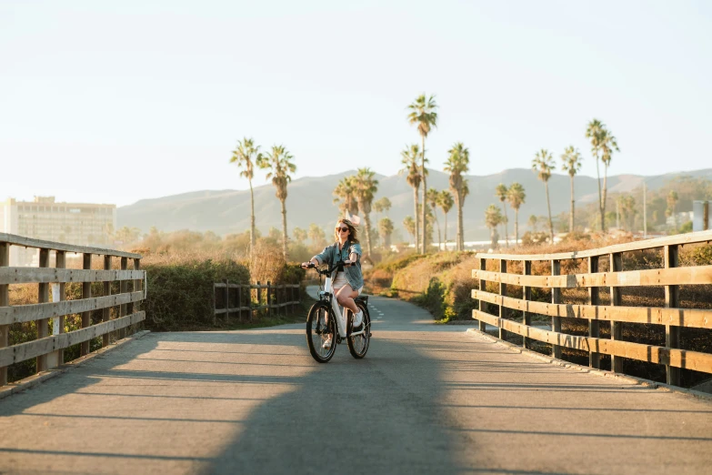 the young man is enjoying riding his bike down the path