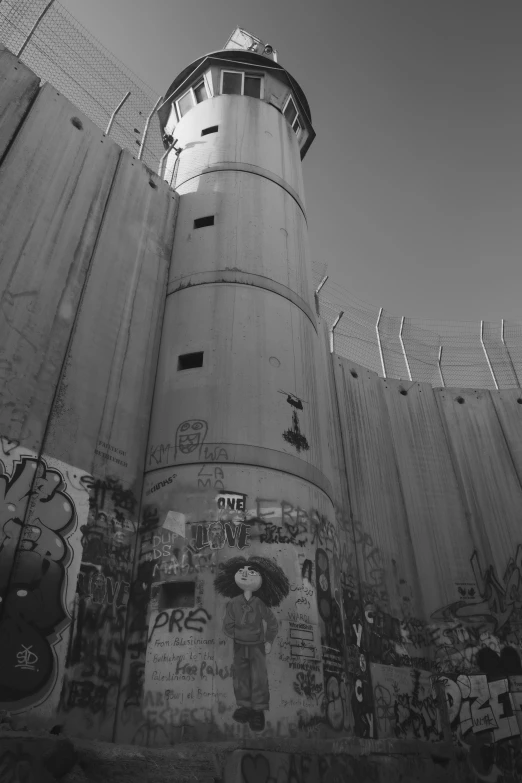 a tall tower with a metal wire railing next to it