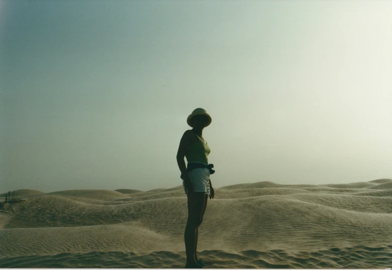 a person standing on a beach in the sand