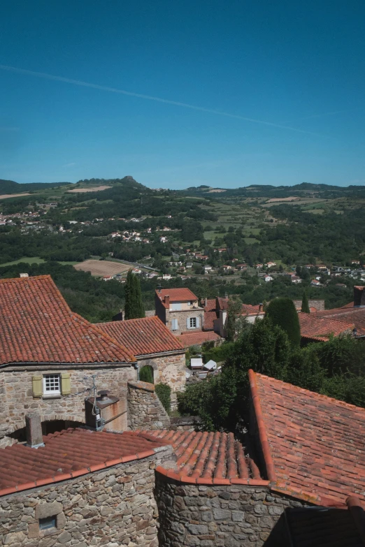 the city is nestled near the mountains with brown tile roofs