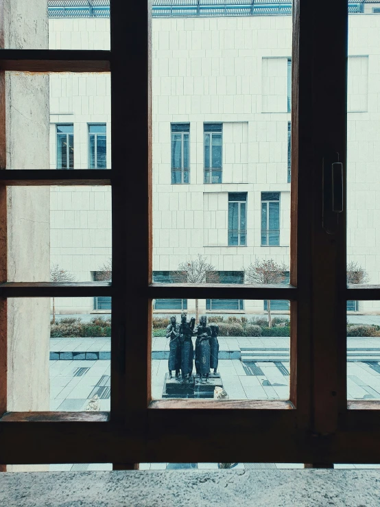 two people sitting at the back window of an office building