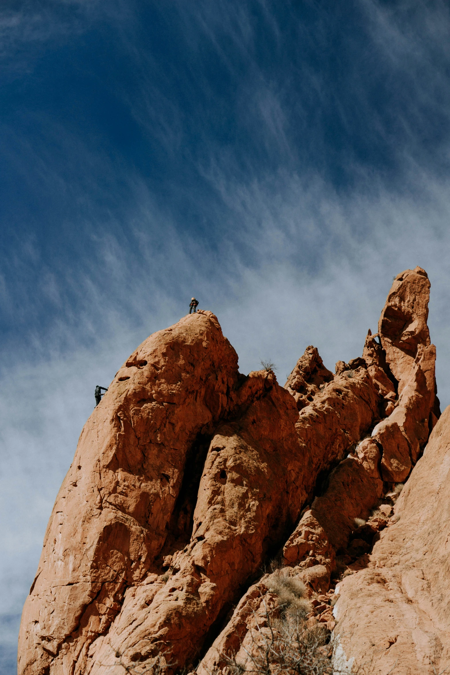 a man is standing on top of a rock formation