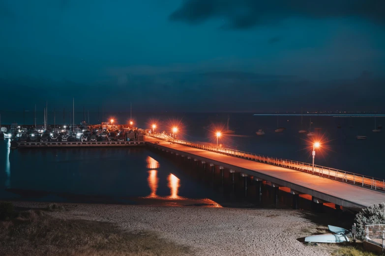 a long dock at night in the city