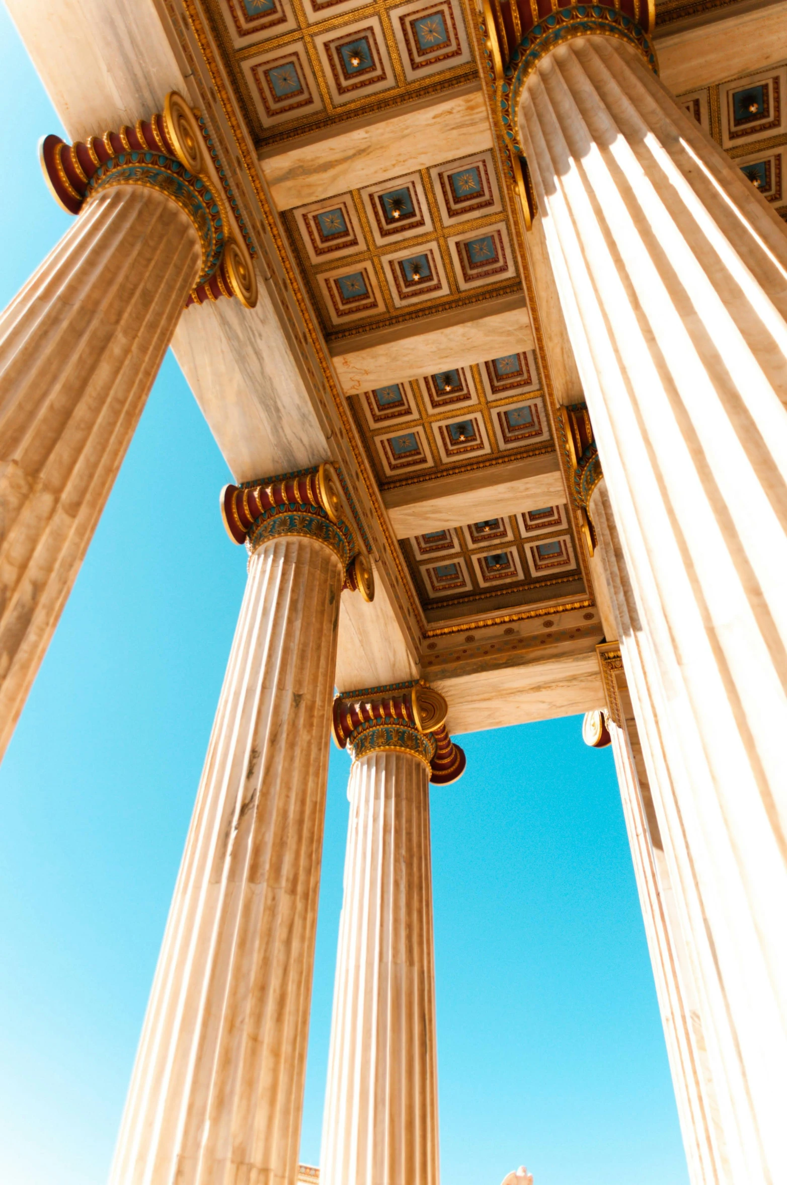 three tall columns with blue sky in the background