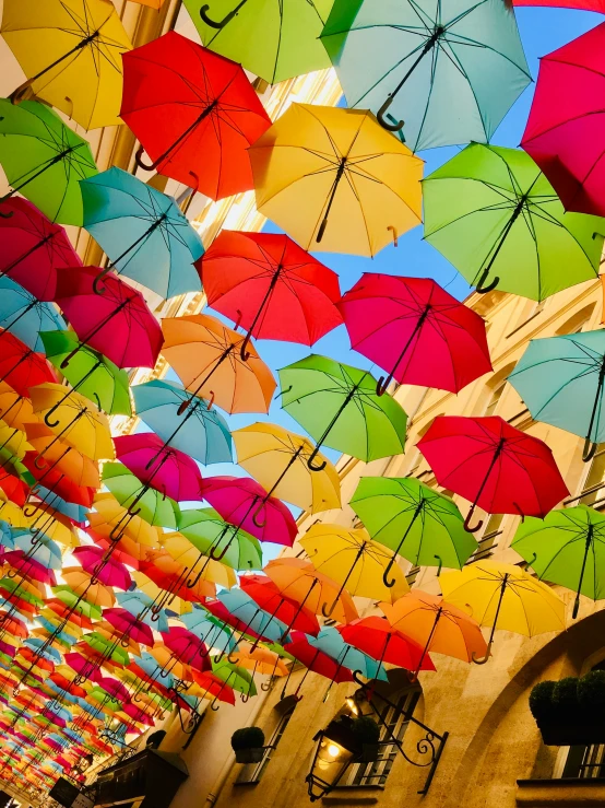 an arrangement of colorful umbrellas covering the ceiling