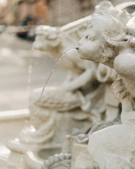 a couple of stone sculptures that are on the side of the street