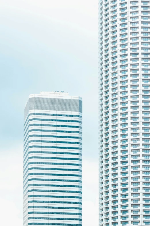 two tall buildings against the sky in a city