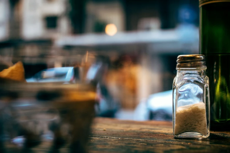 an empty jar and glass on a table with blurry background