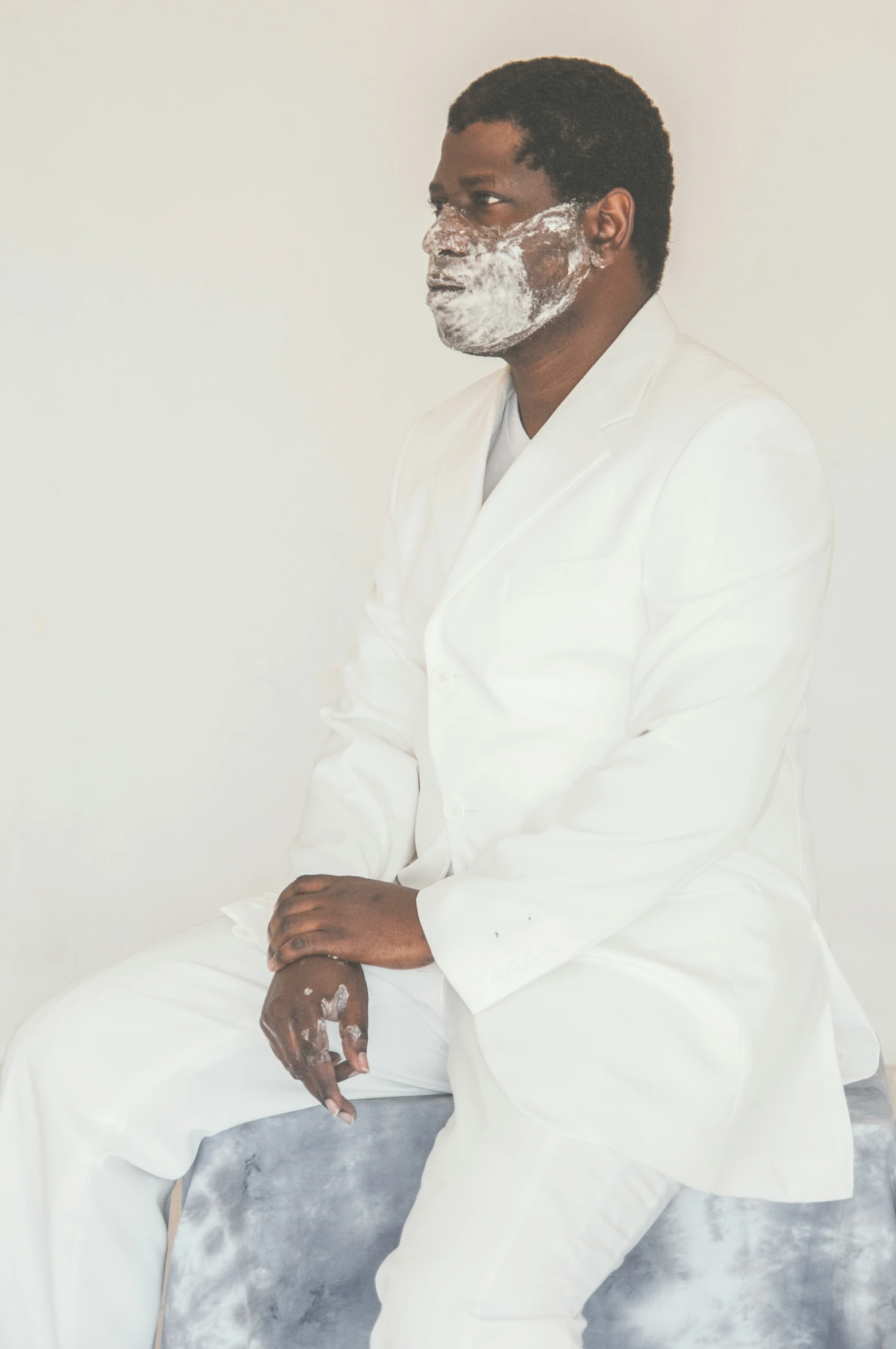 a man with a shaving face sitting down