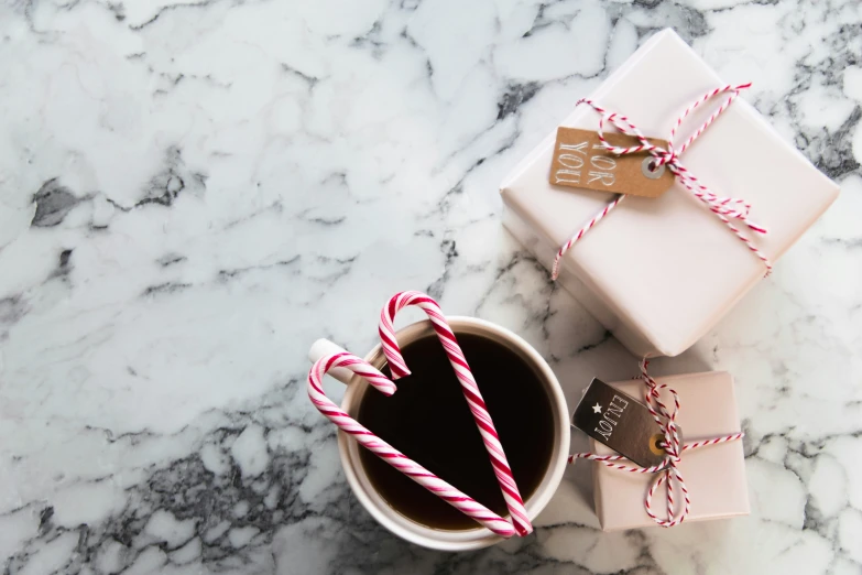 an image of a cup of coffee with christmas presents