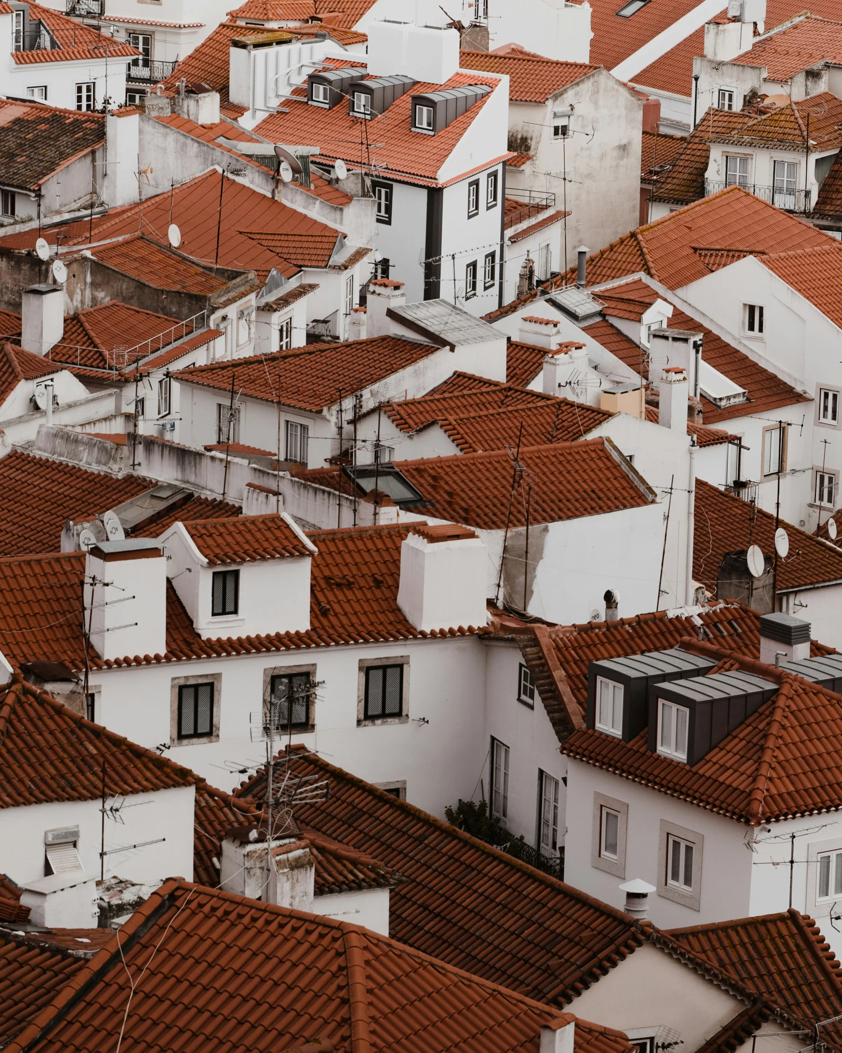 a city with many buildings and rooftops is seen from above