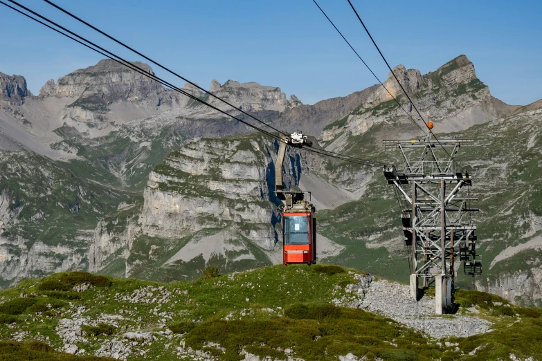 a group of mountains and wires with the lift up to them