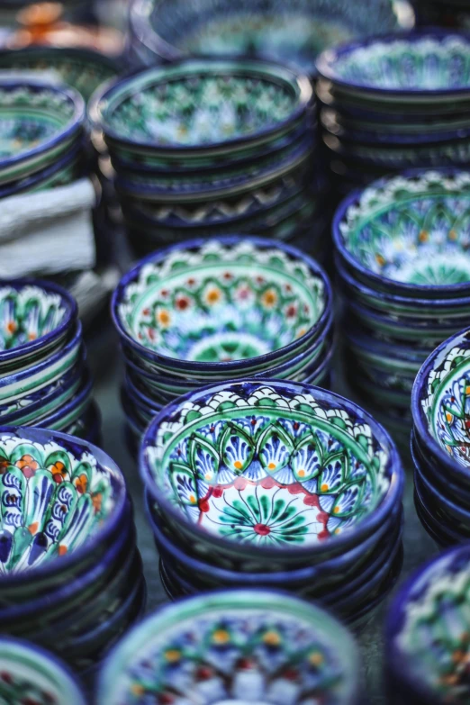 rows of large colored pottery plates with patterns on them