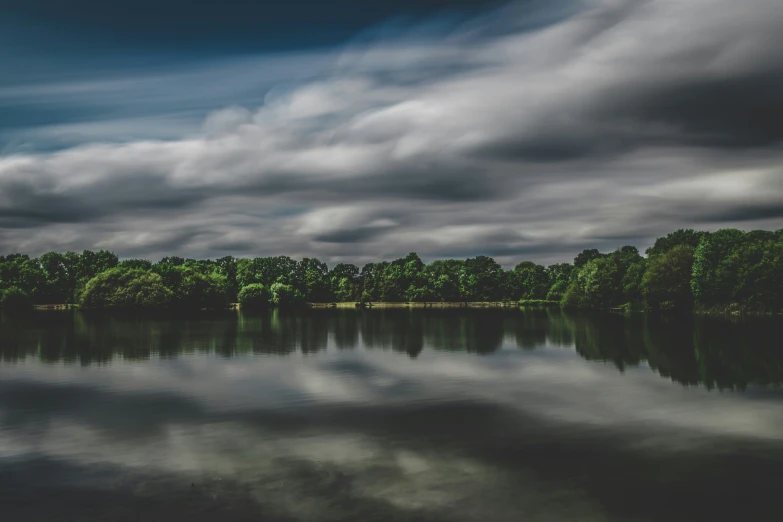 an image of a lake with clouds above