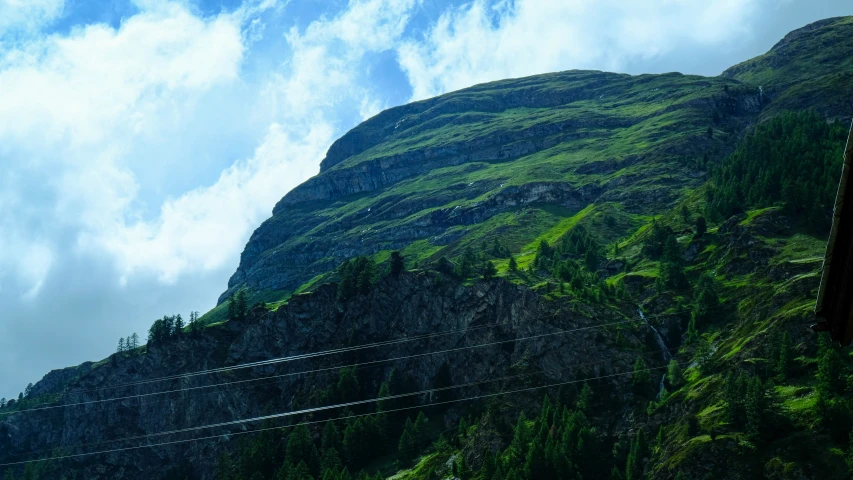 a big mountain with some power lines in front of it