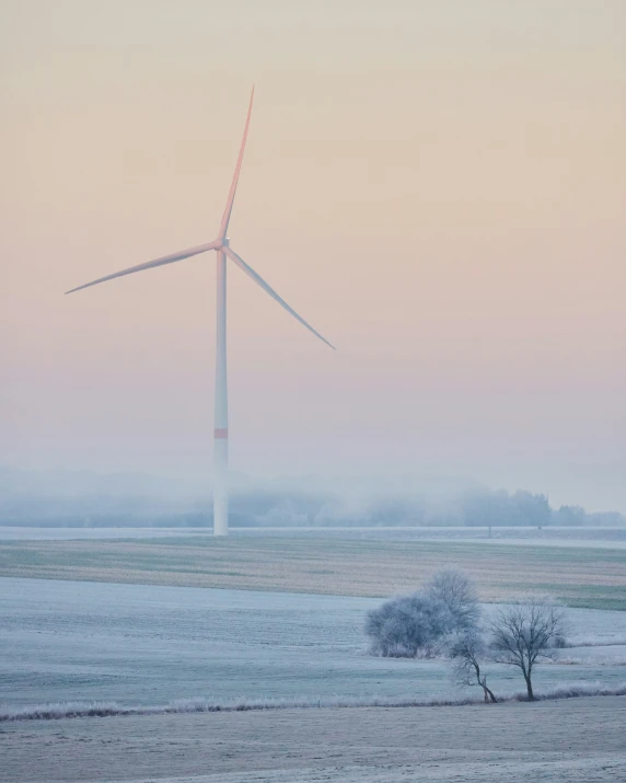 the view of a wind turbine on a snowy field