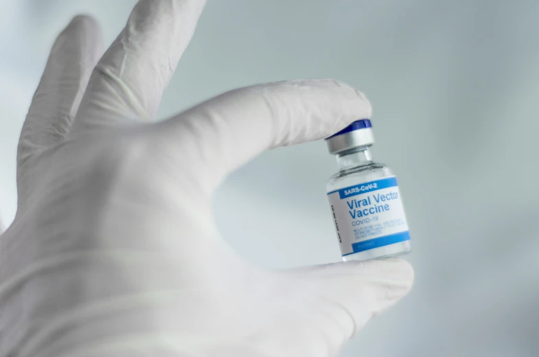 a close up of a person holding an iv bottle