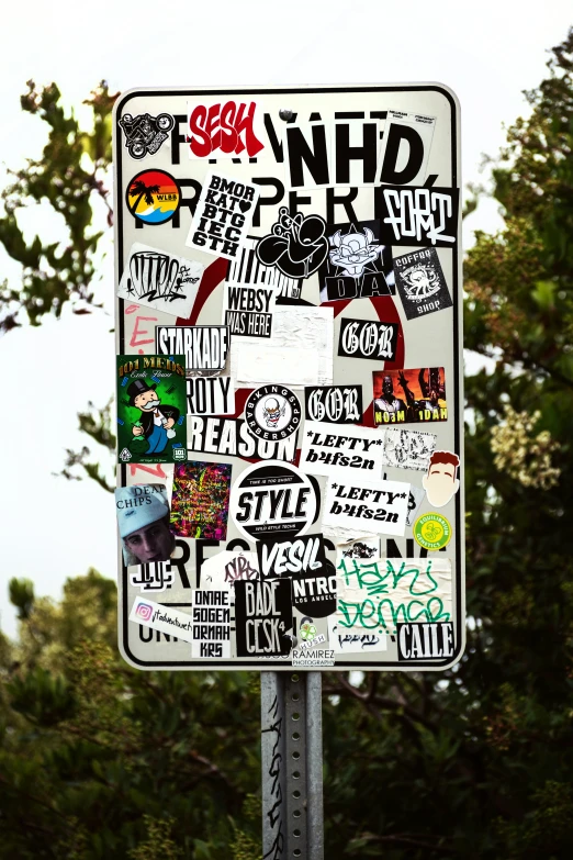 a stop sign with many different graffiti stickers