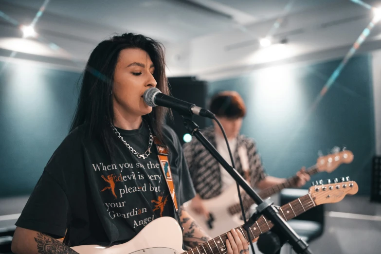 a person standing next to a guitar in a room