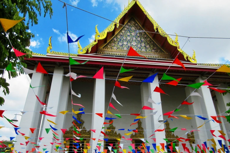 colorful flags are strung in front of a building