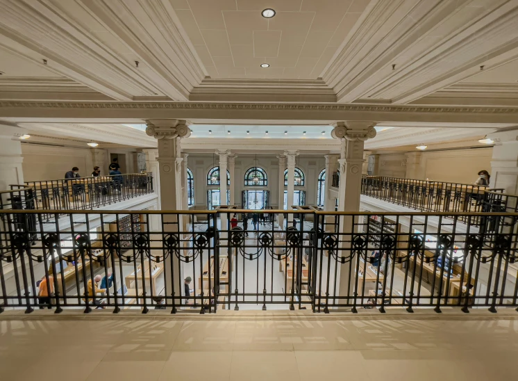 a very large room with a lot of benches and people sitting