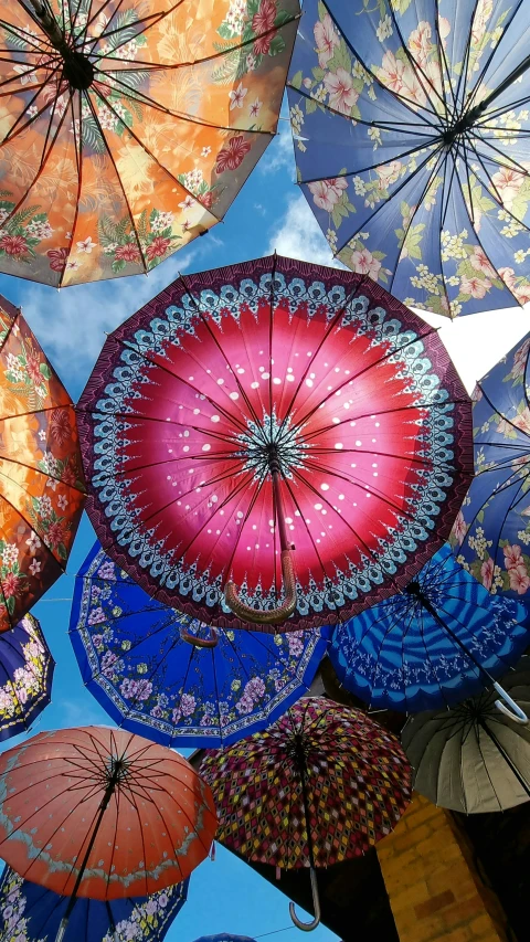 many colorful umbrellas and others with floral designs