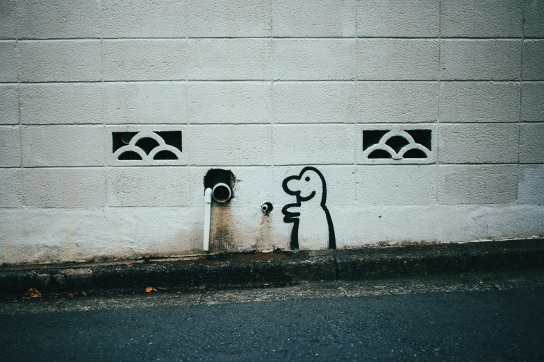 a couple of wall decorations in front of a white brick wall