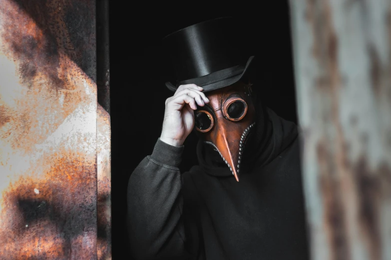 person wearing a top hat and a strange looking mask