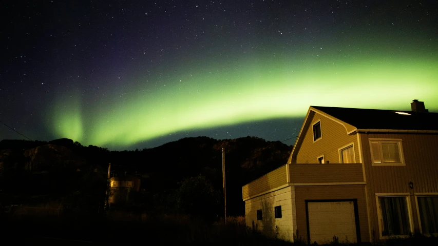 a house and its surroundings are lit up in the sky