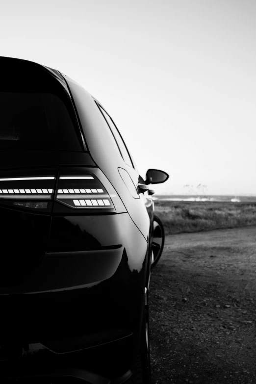 a car is sitting parked in a black and white po