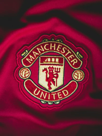the manchester united badge is shown on a jacket