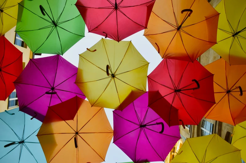 many colorful umbrellas flying in the air