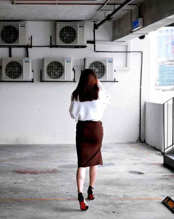 a girl in a white top and brown skirt is outside