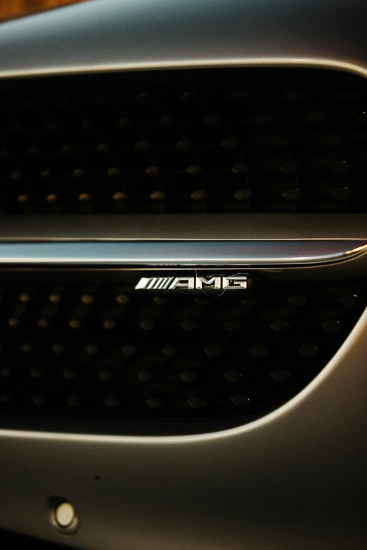 the grille of a car with logo in dark lighting