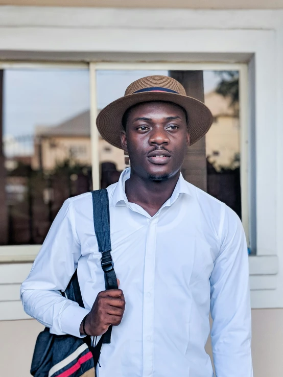 man with suspenders and hat and white shirt