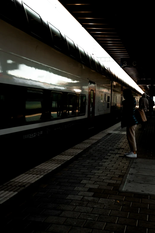 a train on the tracks, in a dark train station