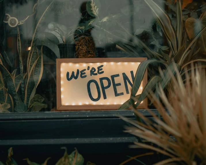 we're open sign on display in the window