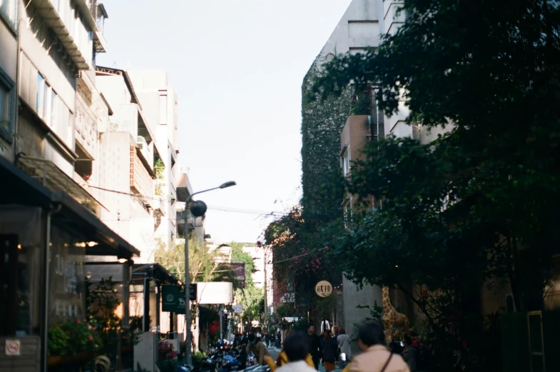 a group of people riding scooters down a street