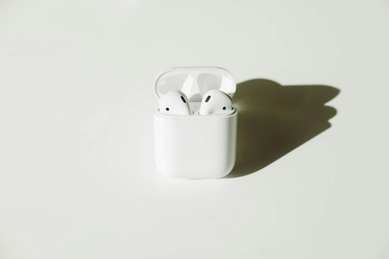 an image of two ear buds in a white case