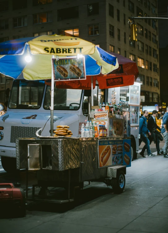 a food truck is parked next to a street