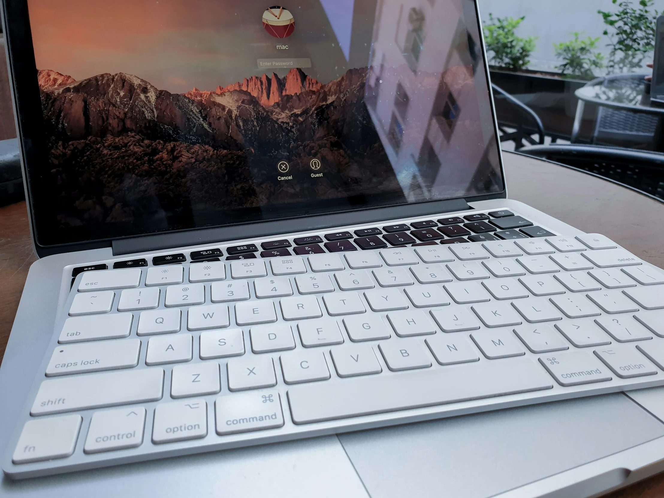 a laptop computer with a silver keyboard sitting on a table