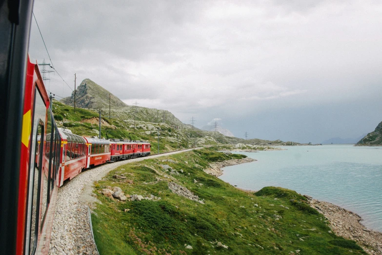 a long train is going by some water