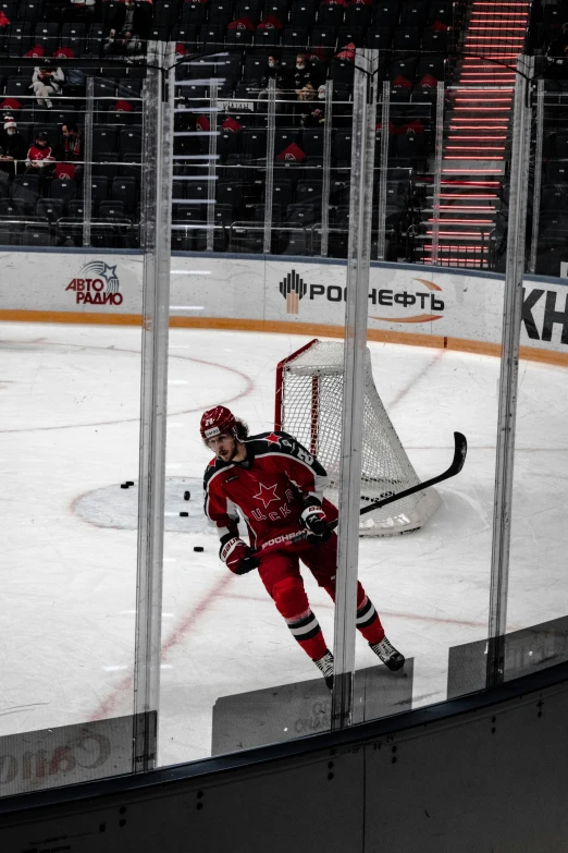 a hockey player on the ice playing in a rink