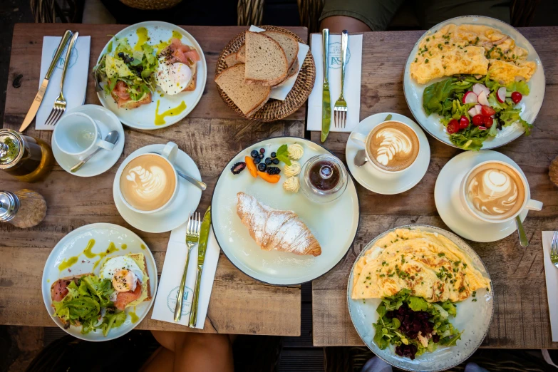 several dishes on a wooden table with coffee