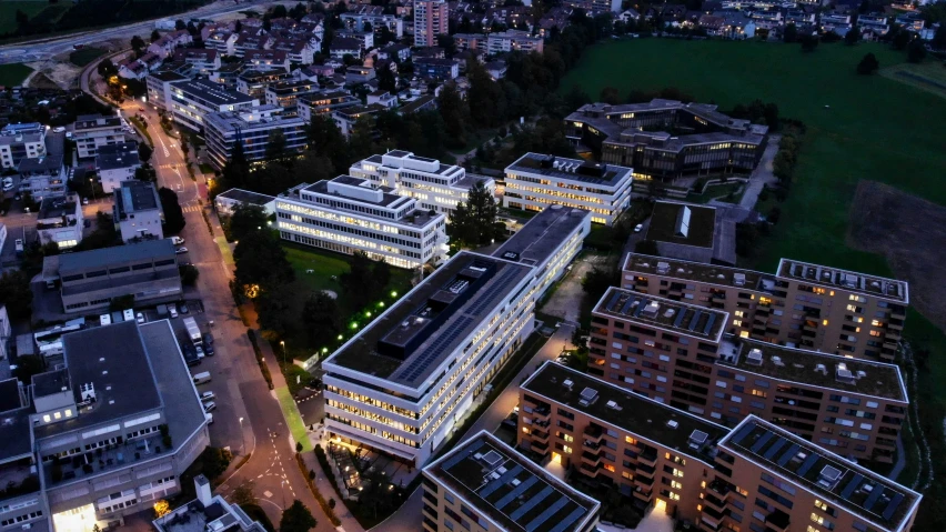 an aerial view of several multi - story building at night