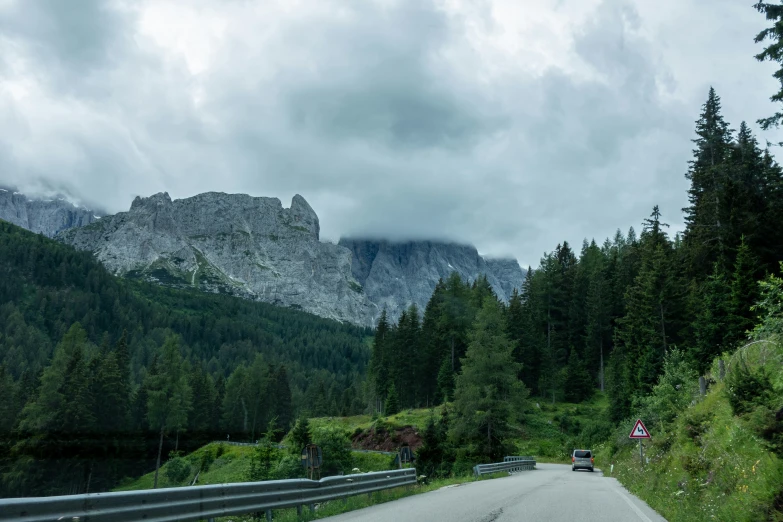 a view of a scenic mountain drive going down the road