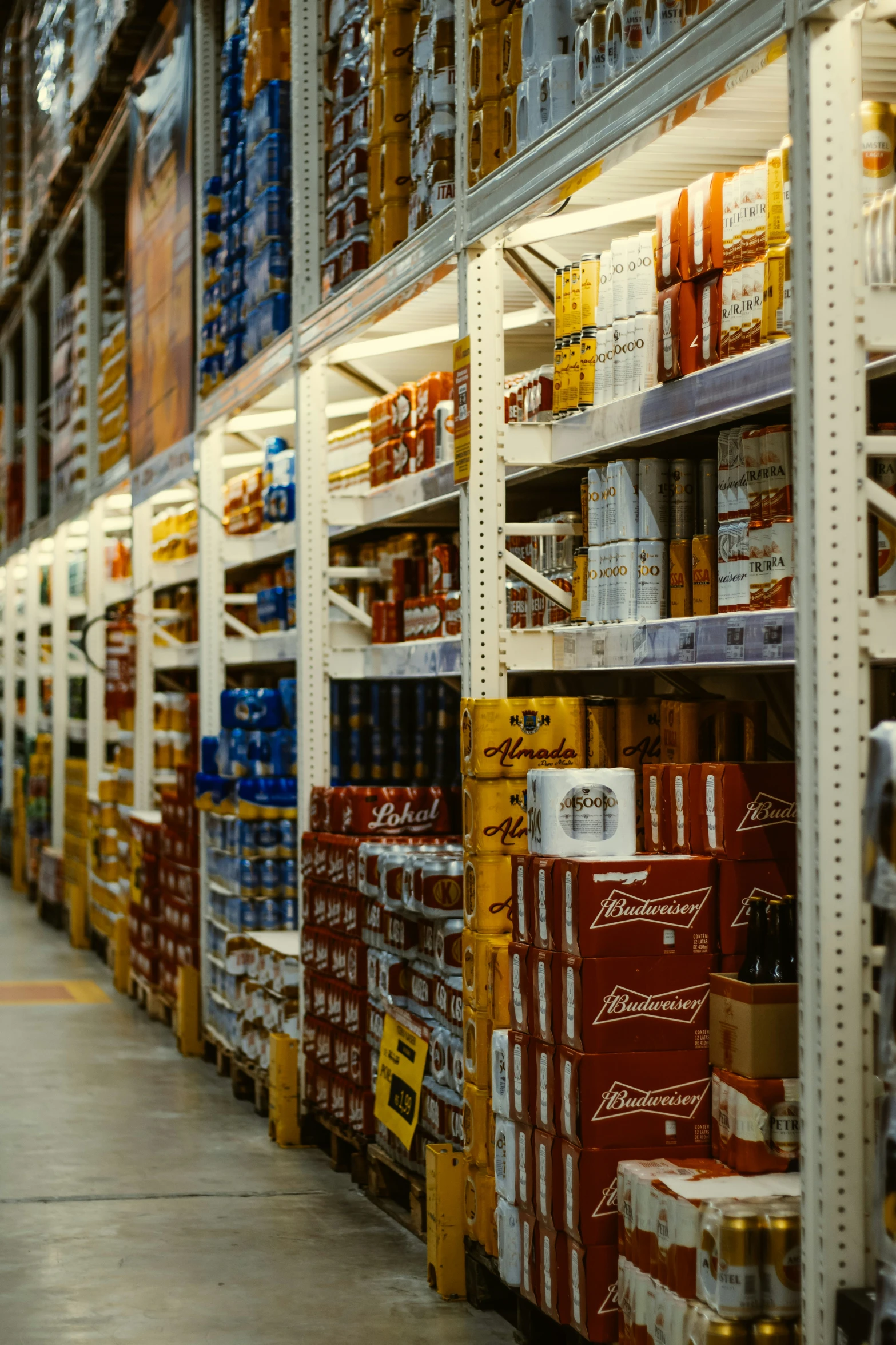 many shelves filled with beer and bottles are lined up