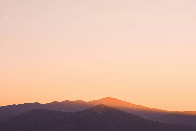 the view of the distant mountain range in the sunset